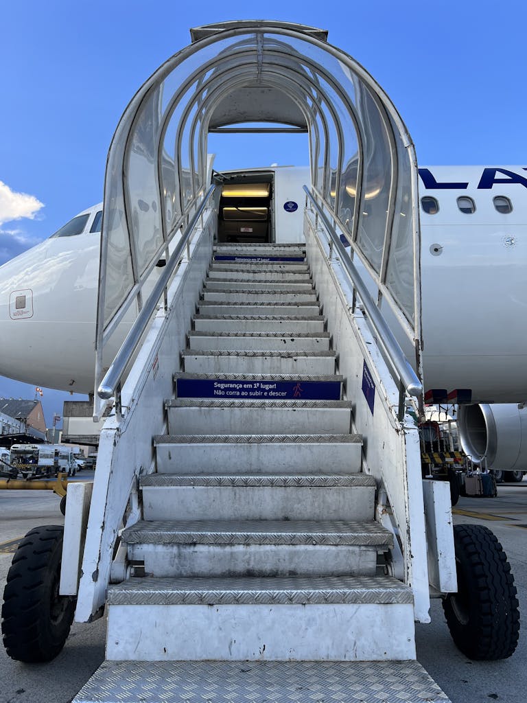 A white airplane with stairs leading up to it