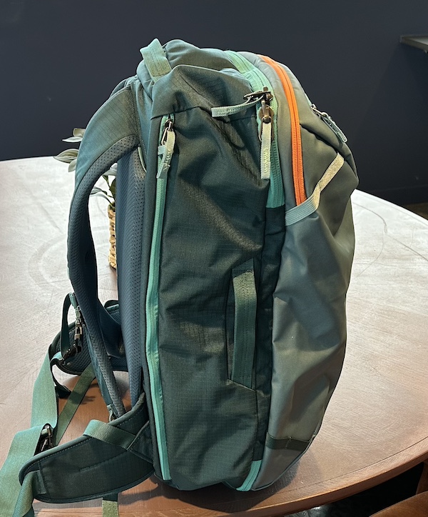 Backpack side view with side handles and hip belt