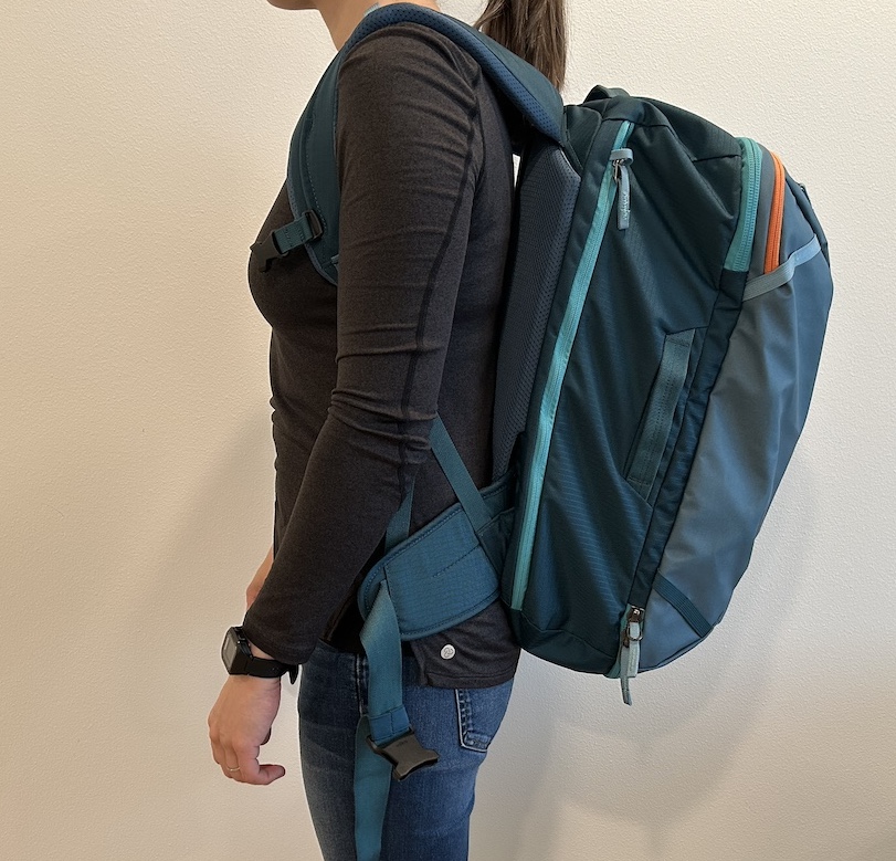 Photo of person wearing travel backpack without hip or chest belt secured.